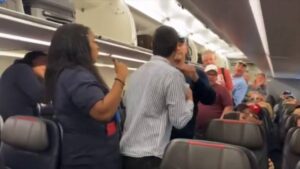 American Airlines passenger headlocked and removed from the plane for lobbing antisemitic slurs at flight attendant