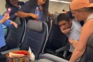 American Airlines passenger headlocked and removed from the plane for lobbing antisemitic slurs at flight attendant